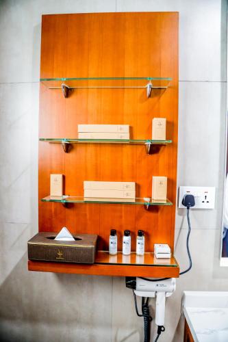 a shelf in a bathroom with three objects on it at Baluba Game Resort in Luanshya