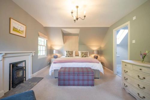 a bedroom with a bed and a fireplace at Secluded Luxury Off-Grid Hideaway with Apartment in Selkirk