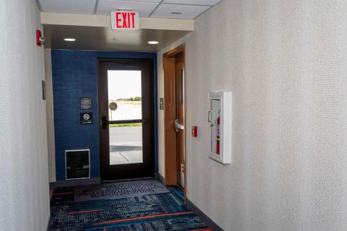 a hallway with a exit sign above a door at Hampton Inn & Suites Riverton in Riverton