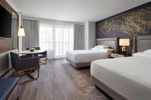 a hotel room with two beds and a desk at Grand Hyatt Washington in Washington