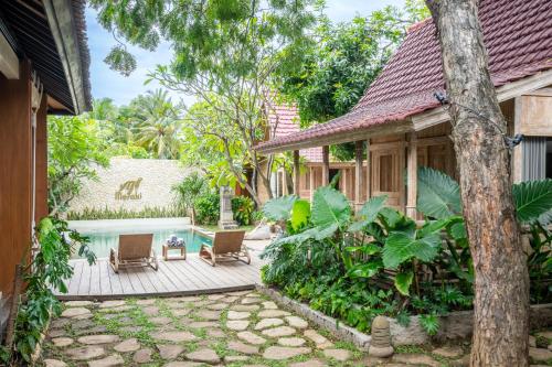 an exterior view of a house with a swimming pool at Meraki Luxury Villa in Pemuteran