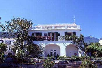 a large white house with a large window at Hotel Gemma in Ischia