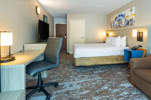 a hotel room with a bed and a desk at Comfort Inn Hwy 401 in Kingston