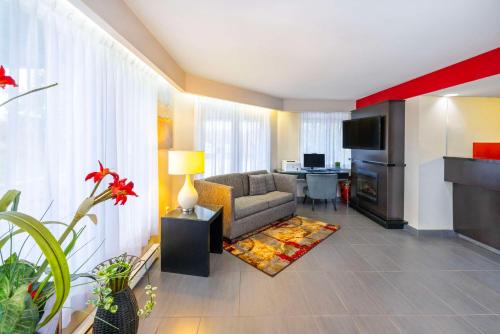 a living room with a couch and a table at Comfort Inn Magnetic Hill in Moncton