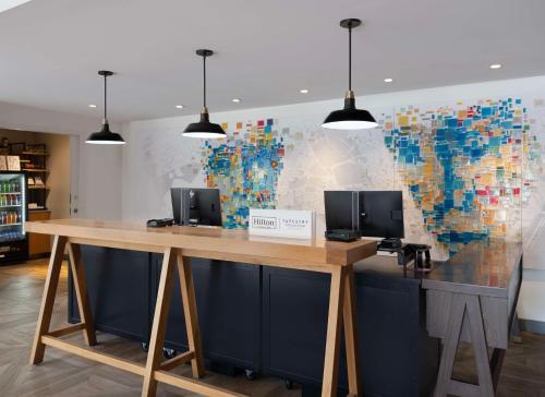 a desk with two monitors on it in a room at Freepoint Hotel Cambridge, Tapestry Collection by Hilton in Cambridge