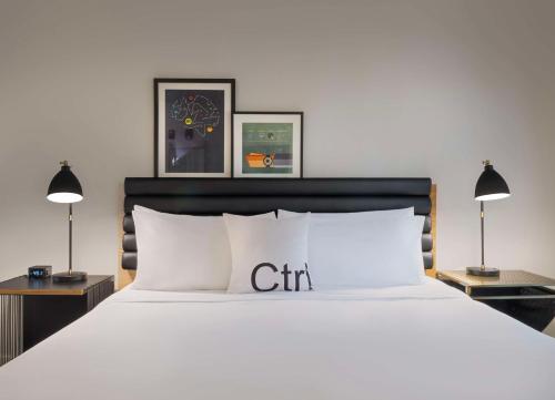 a bedroom with a white bed and two lamps at Freepoint Hotel Cambridge, Tapestry Collection by Hilton in Cambridge