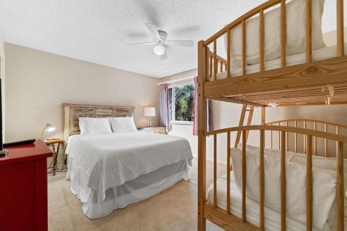 a bedroom with a bed and a bunk bed at Needle Rush Point F12 in Perdido Key
