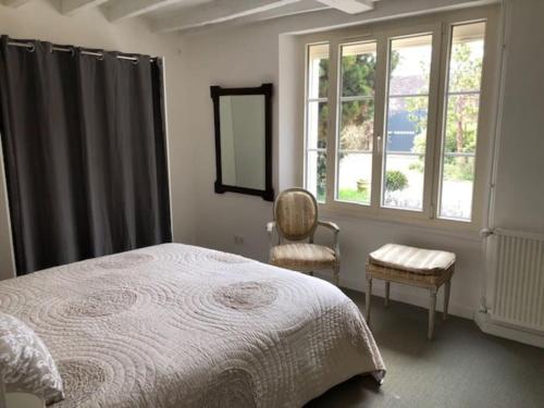 Ένα ή περισσότερα κρεβάτια σε δωμάτιο στο Maison familiale avec poêle à bois et jardin
