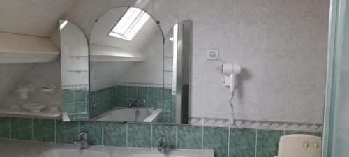 a bathroom with two sinks and a tub and a mirror at Gite Troubadour - Cap Gris Nez - piscine in Audinghen
