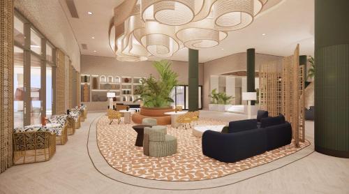 a lobby with a large chandelier and a living room at Zemi Miches Punta Cana All-Inclusive Resort, Curio by Hilton in Miches