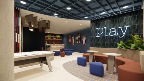 a playroom with tables and chairs and a play sign on the wall at Zemi Miches Punta Cana All-Inclusive Resort, Curio by Hilton in Miches