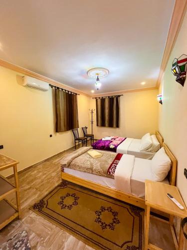 a bedroom with a large bed in a room at Hotel De La Vallée in Aït Baha
