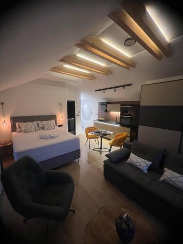 a bedroom with a bed and a living room at NOVA LUXURY DESIGN in Zagreb