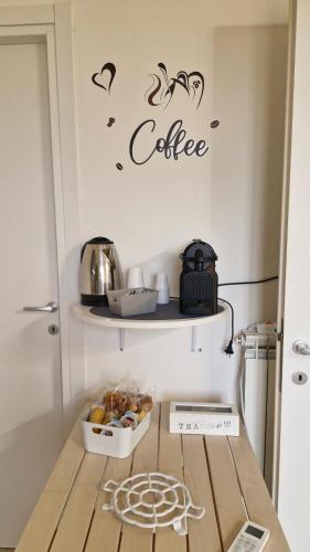 a kitchen with a coffee sign on the wall at HOUSE MAGIE 2 e 3 in Marco Simone