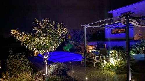 a night view of a house with blue lights at Studio Mimosa in Crest