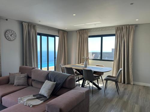 a living room with a couch and a table at Villa Diogo in Ponta do Sol