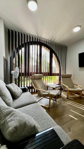 a living room with a couch and chairs and a tv at Apartamentos Lamata in Lamata