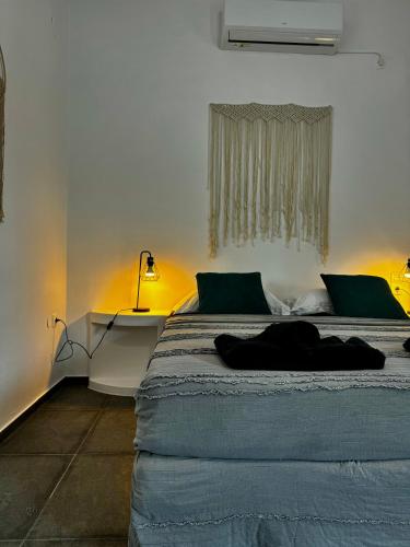 a bedroom with a large bed with a window at Eris Studios in Adamas