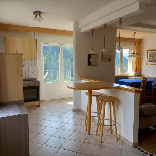 a kitchen with a table and some chairs in a room at Residence Wiesenheim in Trodena