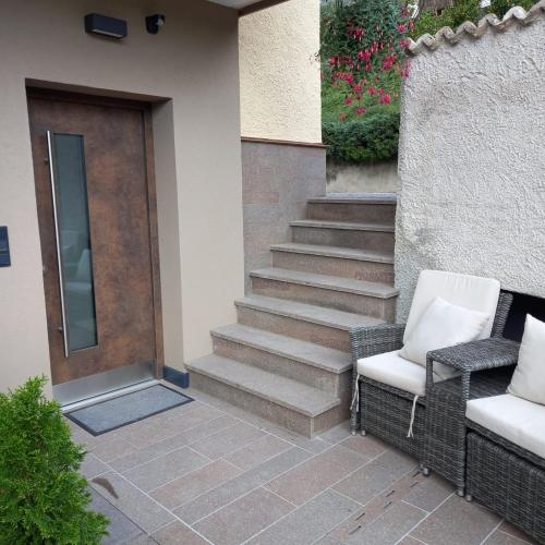 a pair of chairs sitting next to a door at Residence Wiesenheim in Trodena