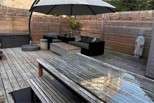 a patio with a table and an umbrella at Lonborough Ave Upstairs in Toronto