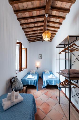 a living room with two beds and a ladder at Agriturismo Casale le Crete in Acquapendente