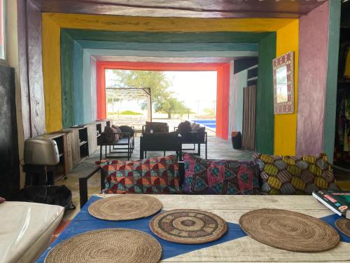 a living room with a table with hats on it at Popbeachclub Suites ilashe in Ibasa