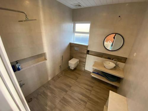 a bathroom with a sink and a mirror at Luxury Basement with Private Pool in Dhok Sandemār