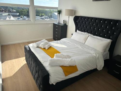 a bedroom with a large bed with towels on it at Flat 303 One bedroom apartment in Birmingham