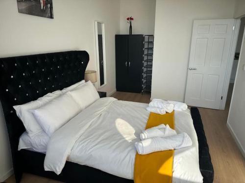 a bedroom with a bed with towels on it at Flat 303 One bedroom apartment in Birmingham