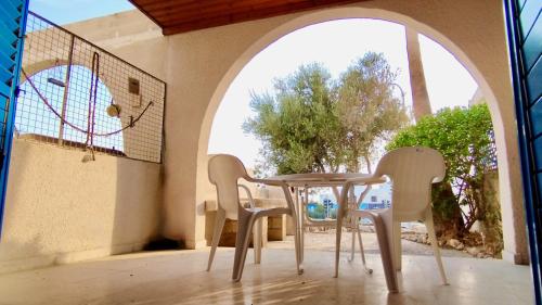 a table and chairs on the balcony of a house at Holiday House in Paphos Tomb of the Kings in Paphos City
