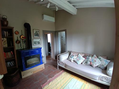 a living room with a couch and a blue fireplace at Borgo Cintoia casa per vacanze in Lucciano
