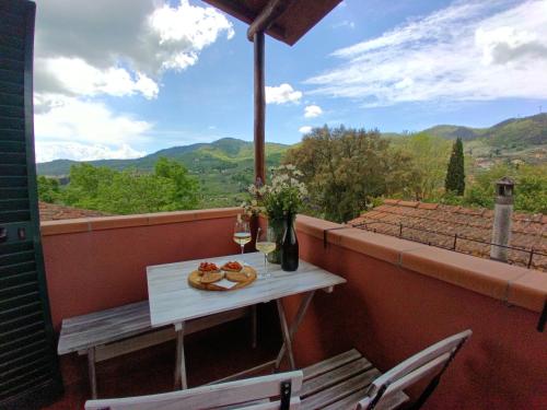 a table and chairs on a balcony with a view at Borgo Cintoia casa per vacanze in Lucciano