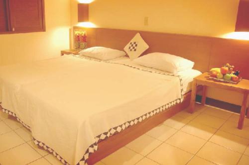 Postel nebo postele na pokoji v ubytování Nyiur Resort Hotel