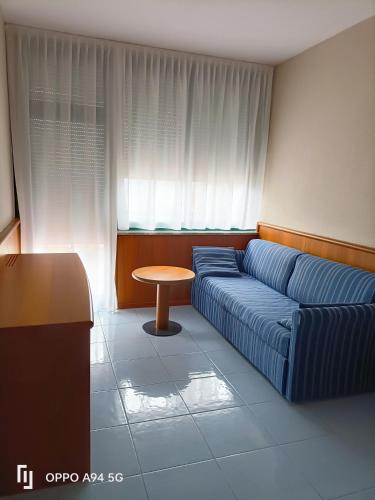 a living room with a couch and a table at Centro Vacanze La Limonaia in Limone sul Garda