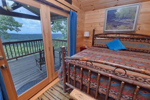 a bedroom with a bed and a balcony with a window at Viva LaVista in Morganton