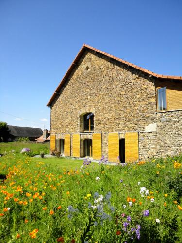 an old stone house in a field of flowers at Dordogne et Corrèze vacances BnB in Troche
