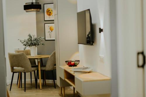 a kitchen and dining room with a table and chairs at Luxury Inn Grand Residences in Tbilisi City