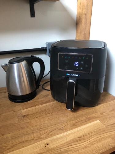 a toaster and a tea kettle on a table at The Barn Mid Bedfordshire in Haynes