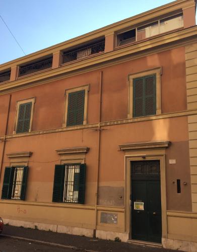 an orange building with black doors and windows at Domus Santa Caterina in Rome