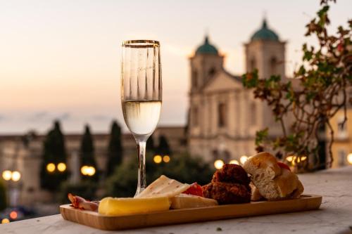 a plate of food and a glass of wine at Antica Loggia in Vibo Valentia