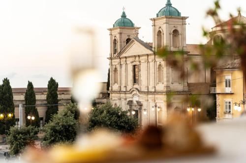 an old building with a church in the background at Antica Loggia in Vibo Valentia