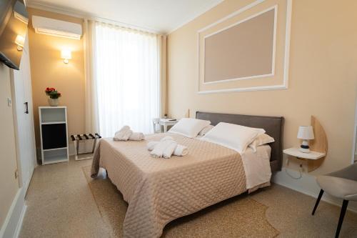 a bedroom with a bed with two towels on it at Antica Loggia in Vibo Valentia