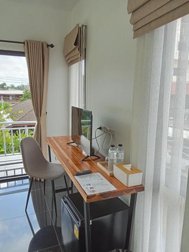 a desk with a computer on it in a room at J-Boutique Hotel เจ-บูทีค โฮเทล in Khon Kaen