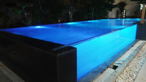 a swimming pool with blue lights on it at BAIA Laiya Marienella Resort in San Juan