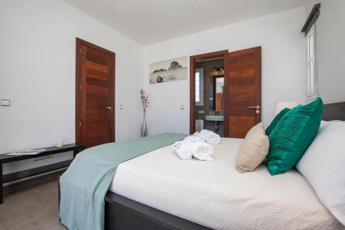 a bedroom with a bed with towels on it at Villa in San Antonio sleeps 10 in Ses Paisses