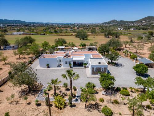 an aerial view of a large white house with trees at Villa in San Antonio sleeps 10 in Ses Paisses