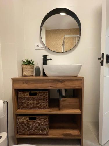 a bathroom with a sink and a mirror at Apartamento Cambil in Baeza