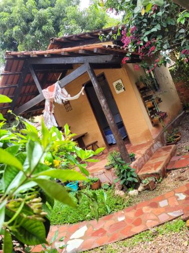 a small house with a garden in front of it at Chalés Toa Rosa in Sao Jorge