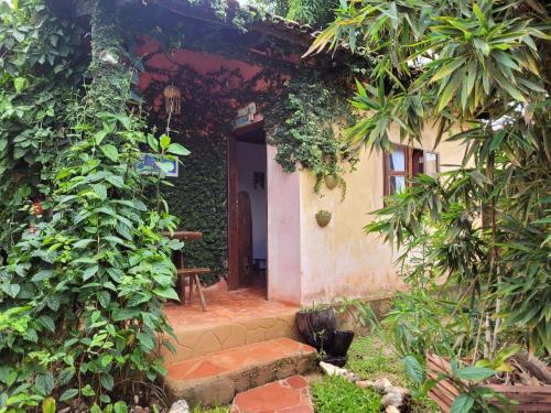 an entrance to a house with a staircase leading to a door at Chalés Toa Rosa in Sao Jorge